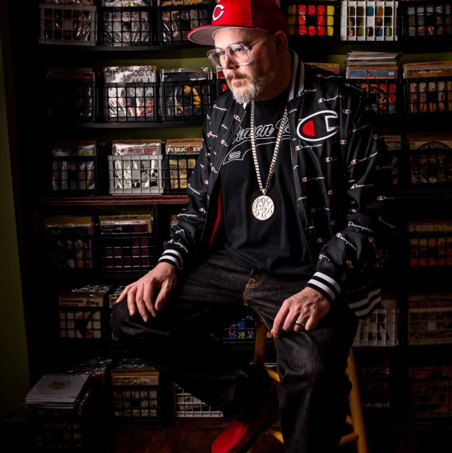 DJ King Otto in front of a portion of his extensive vinyl collection.