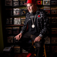 DJ King Otto in front of a portion of his extensive vinyl collection.